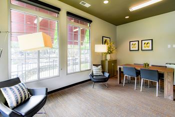 a living room and dining room with a table and chairs at Riverset Apartments, Memphis